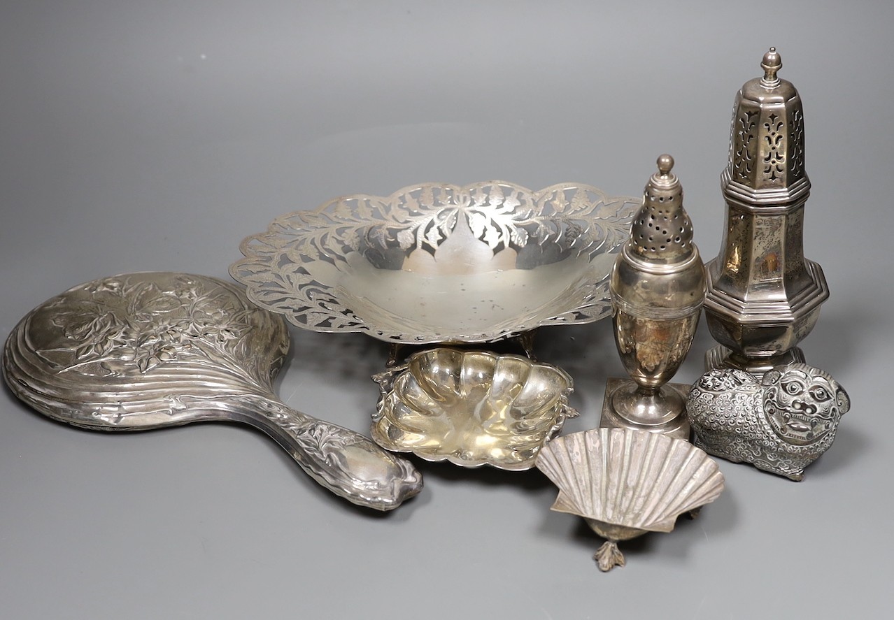 Mixed silver and white metal items including two silver casters, a silver mounted hand mirror, an Egyptian pierced dish, two small dishes and a lion box and cover.